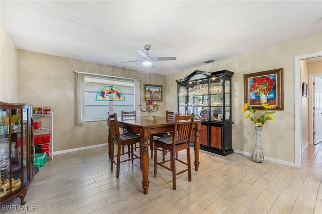 dining area with light hardwood / wood-style floors and ceiling fan