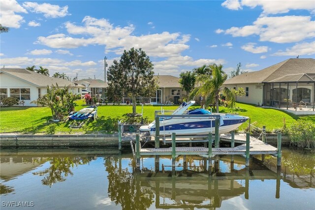 view of dock with a water view and a yard