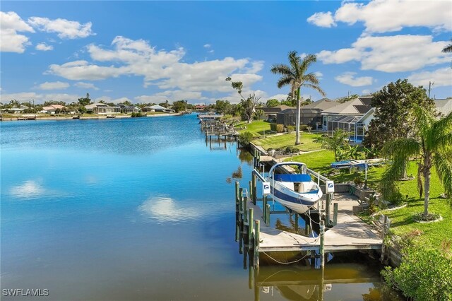 dock area with a yard, a lanai, and a water view