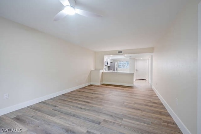 spare room featuring hardwood / wood-style floors and ceiling fan