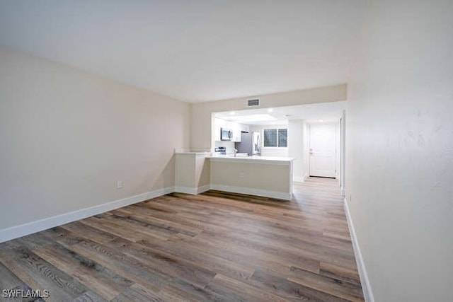 unfurnished living room with hardwood / wood-style floors