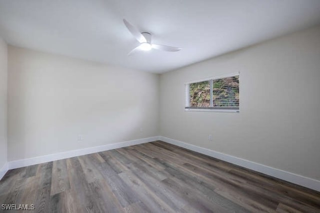 unfurnished room with dark hardwood / wood-style flooring and ceiling fan