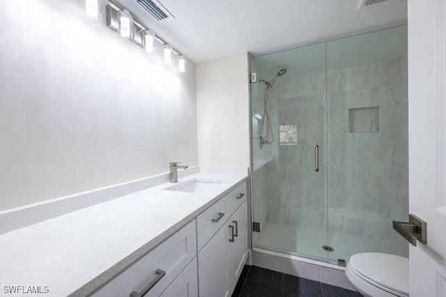 bathroom featuring vanity, walk in shower, tile patterned floors, and toilet