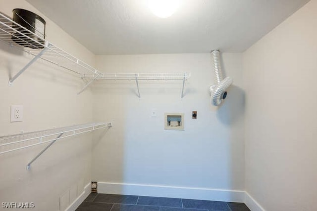 laundry area featuring washer hookup, electric dryer hookup, and dark tile patterned floors