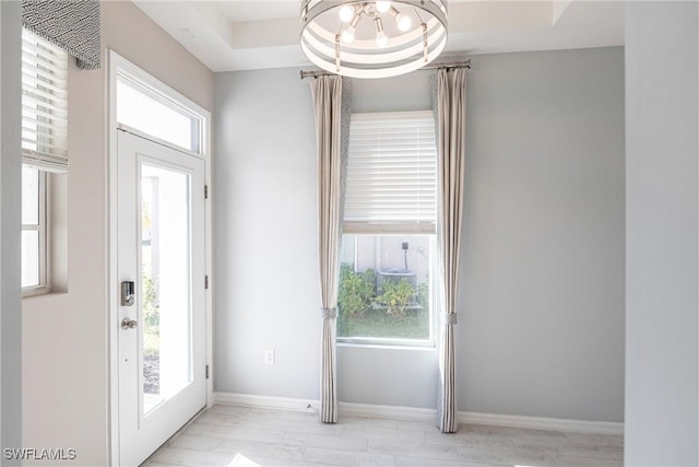 entryway with a raised ceiling