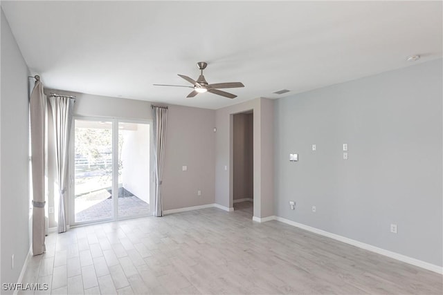 empty room with ceiling fan and light hardwood / wood-style floors