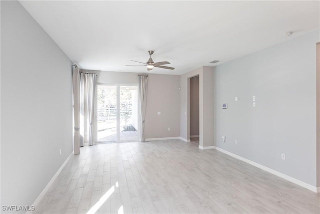 spare room with light hardwood / wood-style floors and ceiling fan