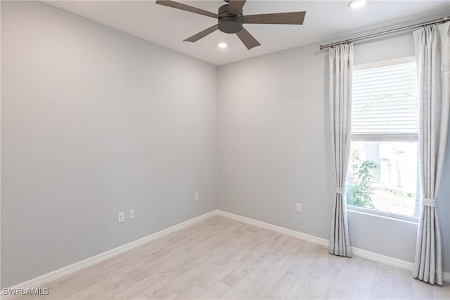 empty room featuring ceiling fan and light hardwood / wood-style floors