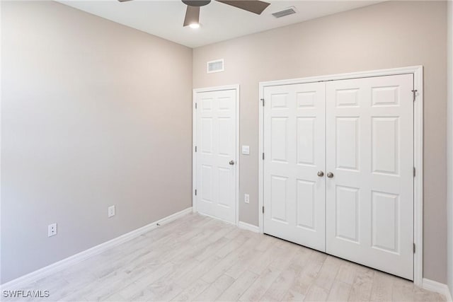 unfurnished bedroom with ceiling fan, light hardwood / wood-style floors, and a closet