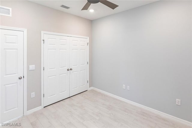 unfurnished bedroom with ceiling fan and light hardwood / wood-style flooring