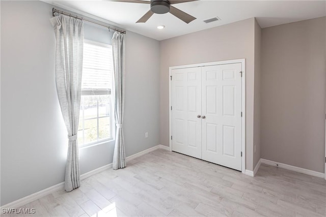 unfurnished bedroom featuring a closet, ceiling fan, and light hardwood / wood-style flooring