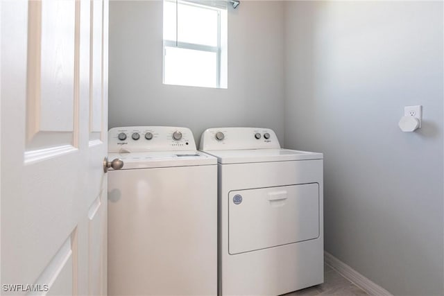 washroom with washing machine and clothes dryer