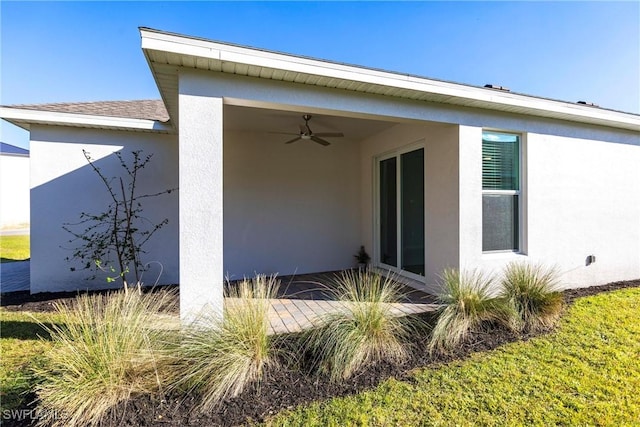 exterior space featuring ceiling fan