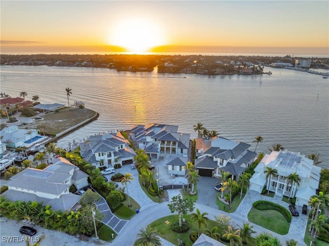 aerial view at dusk with a water view