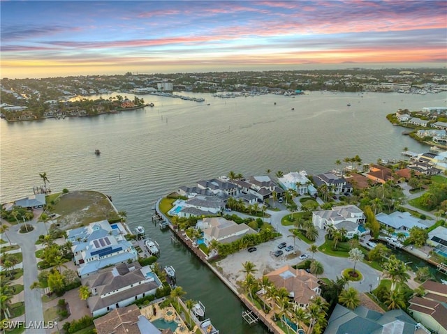 aerial view at dusk with a water view