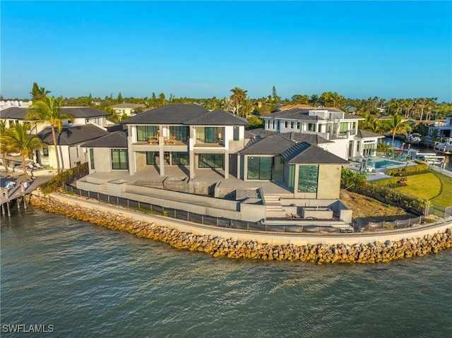 back of house featuring a patio area and a water view