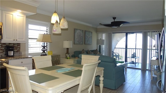 dining room with ornamental molding, wood-type flooring, and ceiling fan