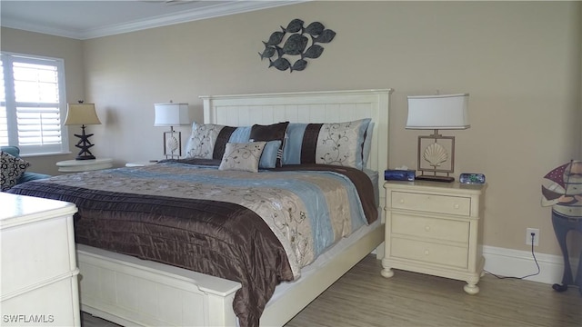 bedroom featuring hardwood / wood-style flooring and ornamental molding