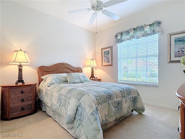 bedroom with ceiling fan and light carpet