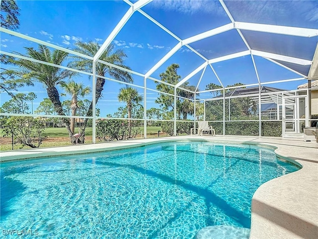 view of swimming pool featuring a lanai and a patio