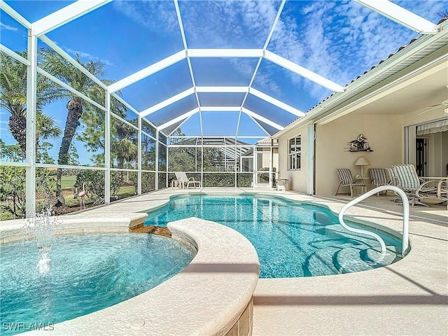 view of pool with a patio, ceiling fan, and glass enclosure