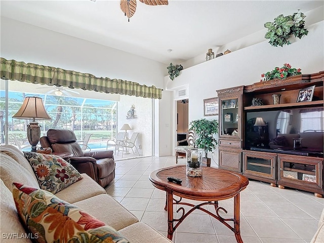 tiled living room with ceiling fan