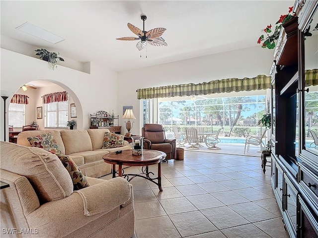 tiled living room with ceiling fan