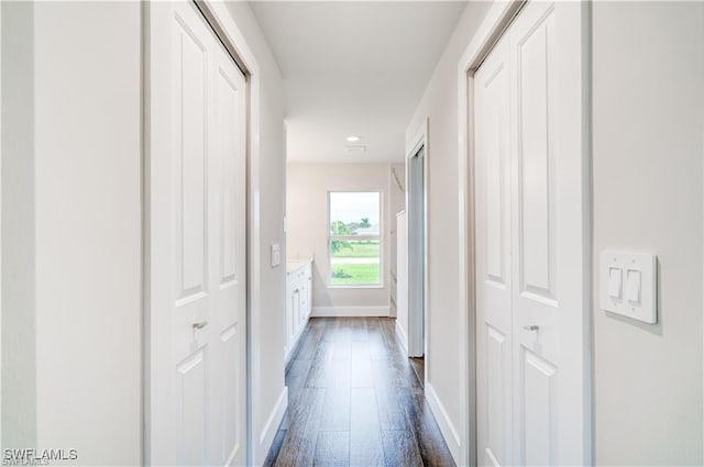 hallway with dark hardwood / wood-style floors