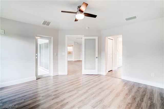 unfurnished room with ceiling fan and light wood-type flooring