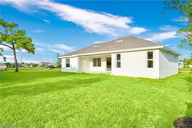 back of house featuring a yard