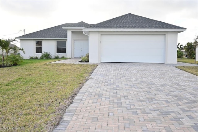 view of front of property featuring a garage and a front lawn