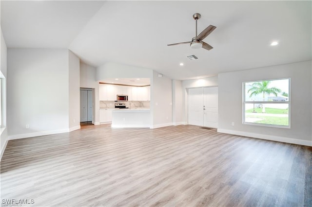 unfurnished living room featuring vaulted ceiling, ceiling fan, and light hardwood / wood-style floors