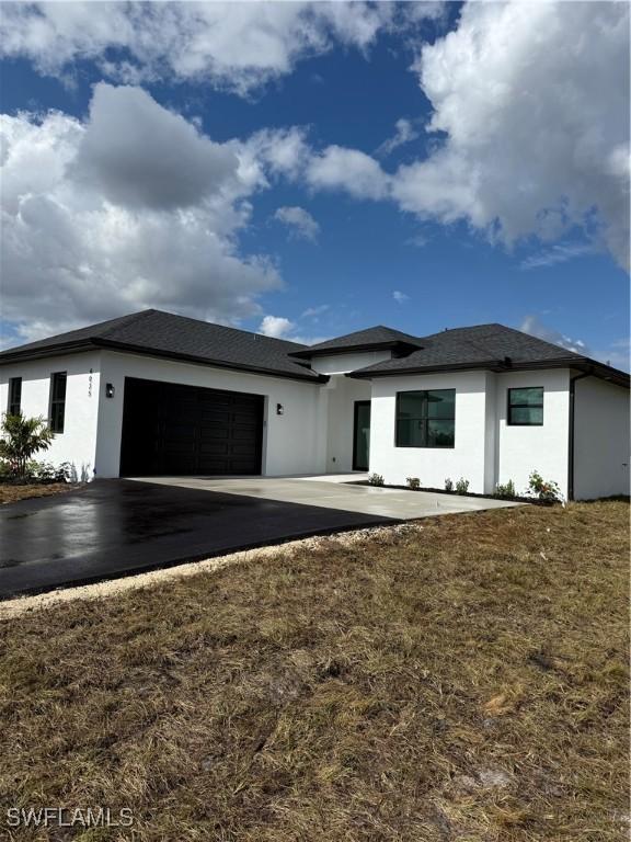 view of front facade with a garage and a front lawn