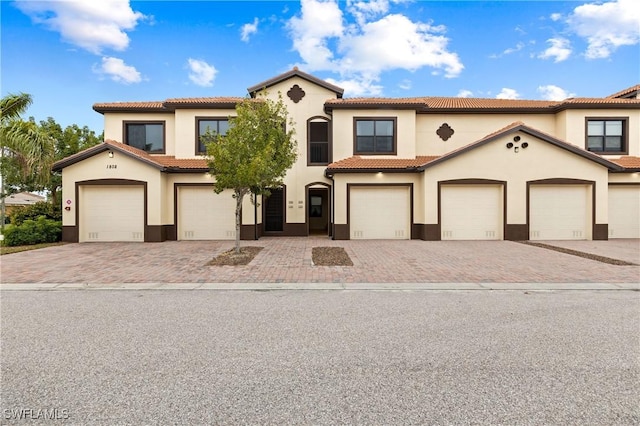 mediterranean / spanish-style home with a garage