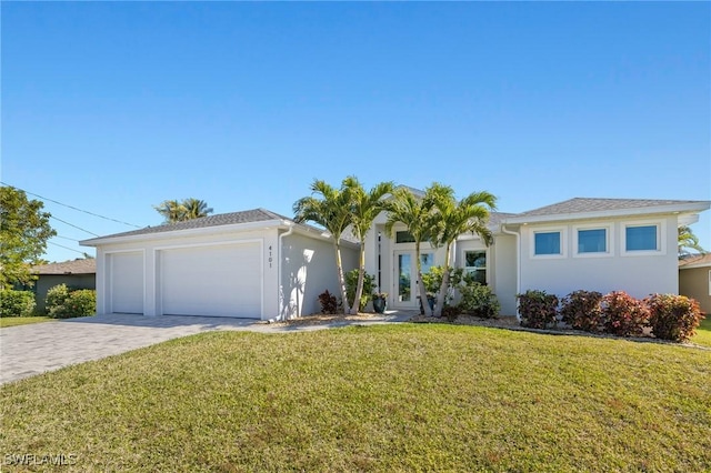 ranch-style home featuring a garage and a front lawn