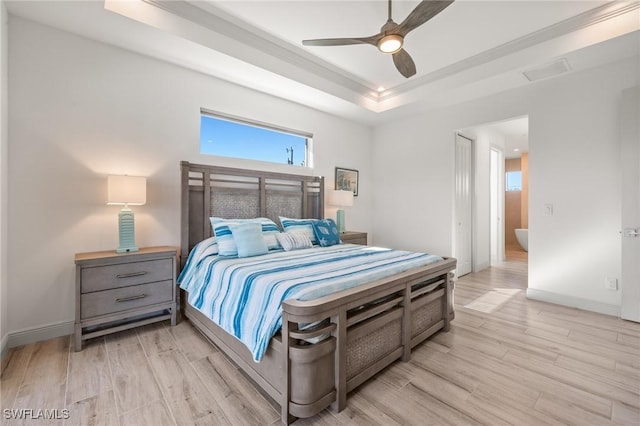 bedroom featuring ornamental molding, light hardwood / wood-style floors, a raised ceiling, and ceiling fan