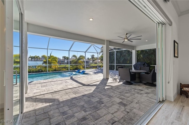 view of patio / terrace featuring a lanai and ceiling fan