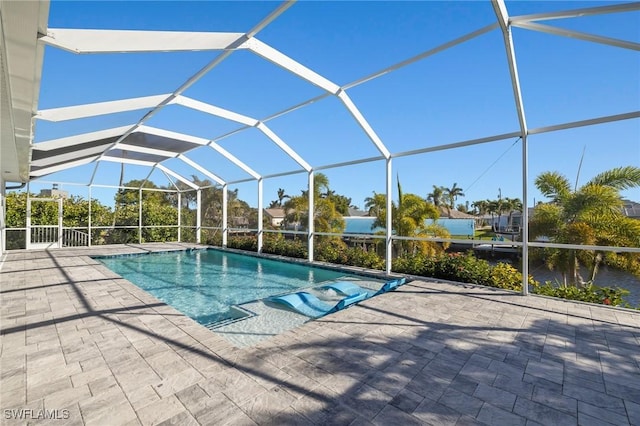 view of pool with a patio and glass enclosure