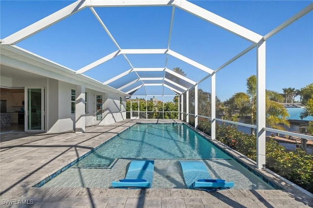 view of swimming pool with a lanai and a patio