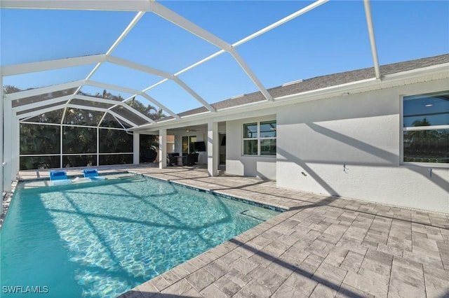 view of swimming pool with a lanai and a patio area