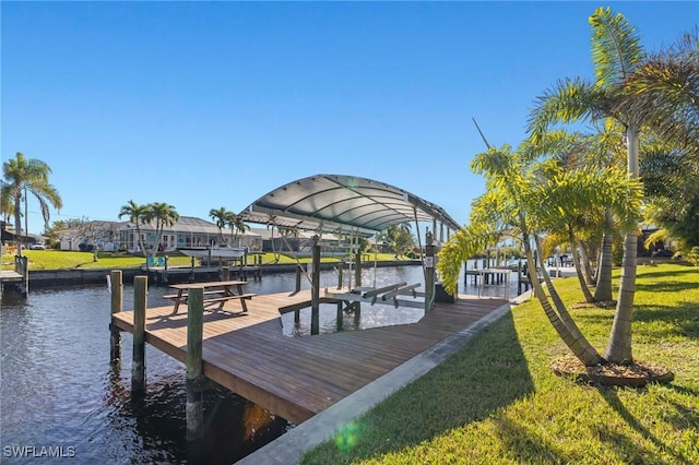 dock area featuring a water view and a yard