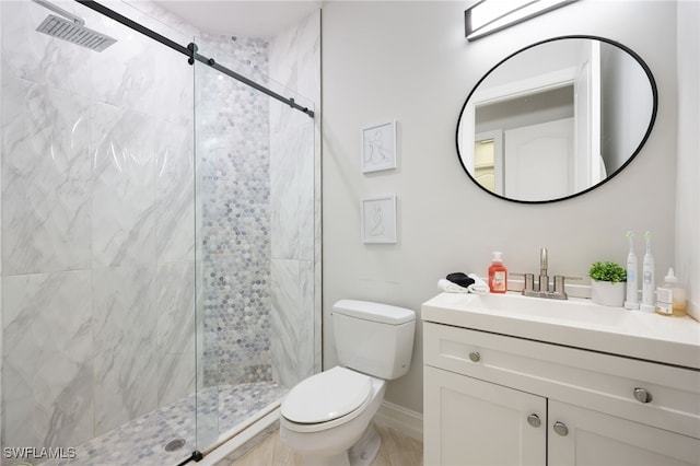 bathroom featuring vanity, toilet, and a shower with shower door