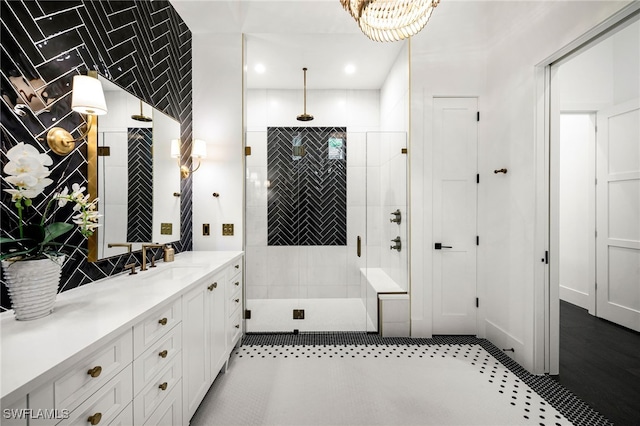 bathroom featuring vanity, a shower with shower door, and tile patterned floors