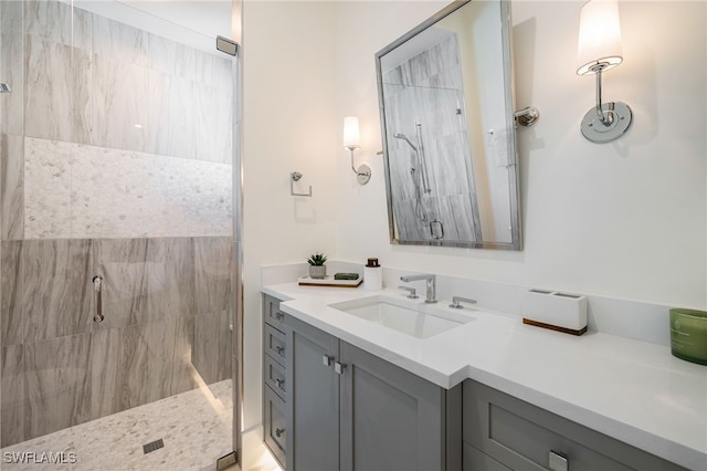 bathroom with vanity and a shower with door