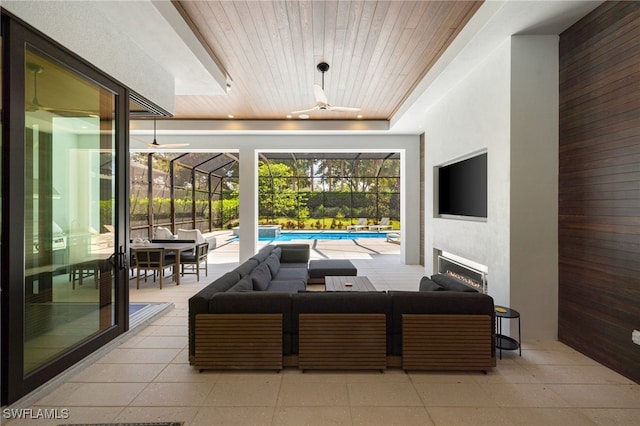 interior space featuring a tray ceiling, a fireplace, and wooden ceiling