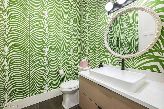 bathroom featuring vanity, hardwood / wood-style floors, and toilet