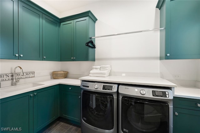 laundry room featuring separate washer and dryer, sink, dark hardwood / wood-style floors, and cabinets