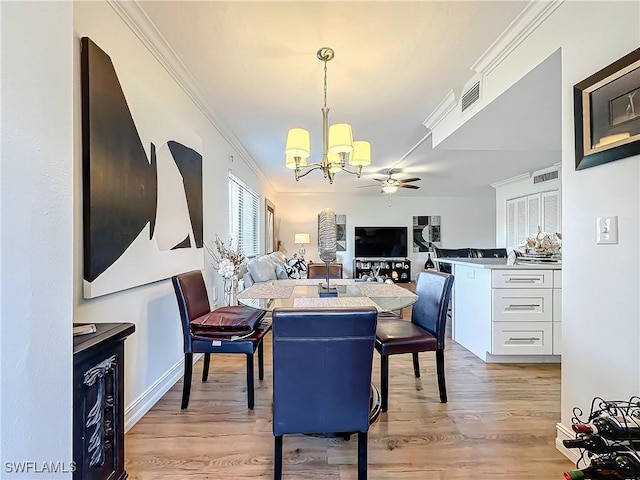 dining room with crown molding, light hardwood / wood-style flooring, and ceiling fan with notable chandelier