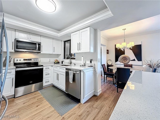 kitchen featuring sink, white cabinets, ornamental molding, stainless steel appliances, and light wood-type flooring