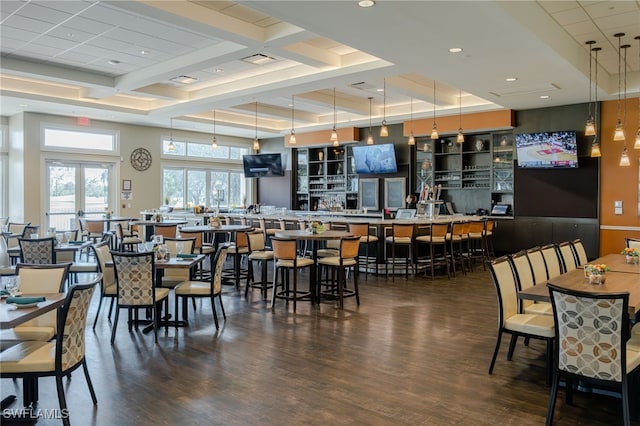 dining area featuring coffered ceiling, dark wood-type flooring, and french doors